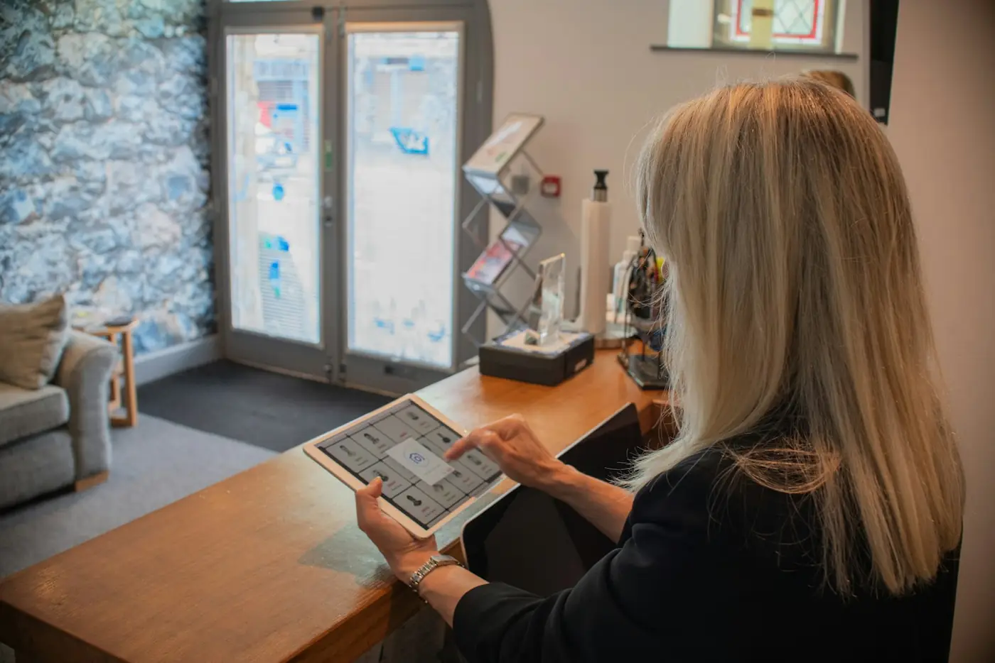 A receptionist answering a customer on a tablet