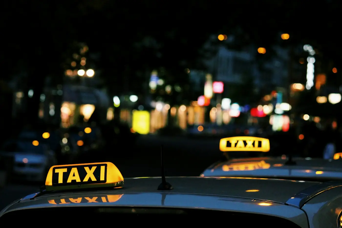 A lit taxi sign at night